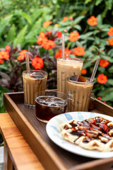 Cold milk coffee cups in Da Lat city, Vietnam style on table. Selective Focus.