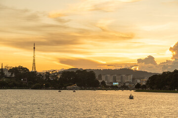 Sunset view of a Da Lat City with development buildings, transportation, market. Tourist city with center square of Da Lat city near Xuan Huong lake