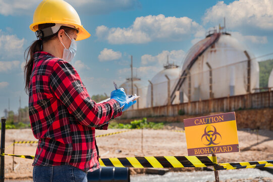 Female Petrochemical Engineer Worker Checks The Gas Storage Industry And Oil Refinery Plant Industry For Quality Control And Natural Environment To Prevent Biohazards.