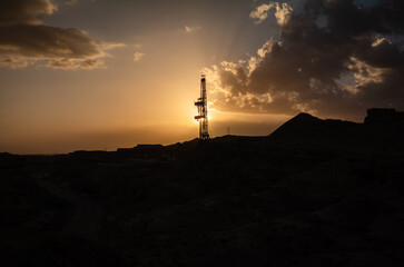 Silhouette of Oil Derrick under the Setting Sun