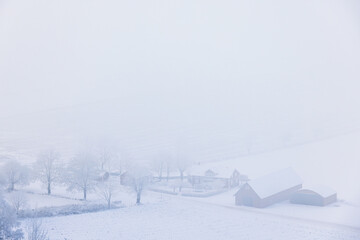 Fototapeta na wymiar Farm in the countryside on a foggy winter day
