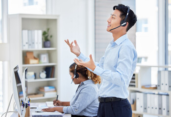 Customer service, man and standing for consulting in call centre with headset, talking and hand...