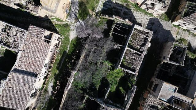 Overhead drone shot of ruins of houses in Poggioreale, a village that was severely damaged by the 1968 Belice earthquake in Sicily Italy
