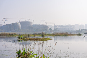 High rise buildings under construction by the lakeside