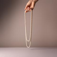 Pearl necklace in woman hand