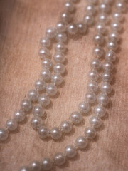 Pearl necklace under beige silk fabric