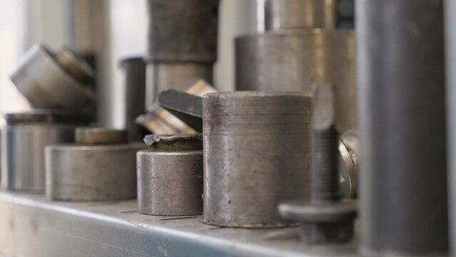 Close-up of a shelf with silent blocks at a car service station, various tools and accessories. Modern auto repair shop. Replacement of the silent block.
