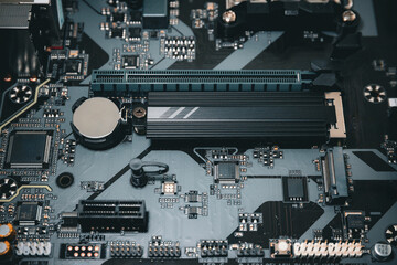 CMOS backup battery CR2032,Pci-express,SATA Port, circuit on a modern black motherbord. Computer...