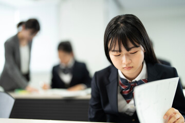 教室で勉強している制服の高校生
