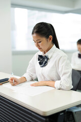 教室で勉強している制服の高校生