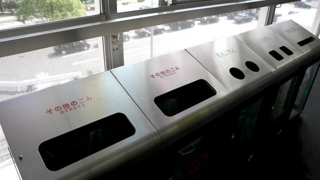 Metal Recycling Trash Bins Located On Shin Osaka Station Platform. Slow Motion Panning Shot