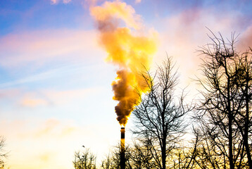 Emission of smoke and vapors from the chimney of an industrial plant into the environment....
