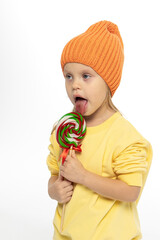 Portrait of funny little blonde girl with sweets lollipop in her hand. High quality photo