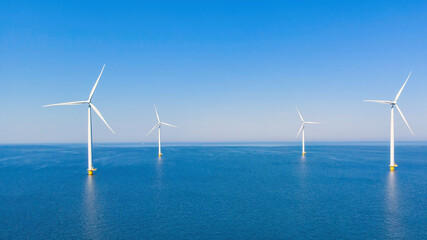 Windmill turbines offshore at sea with a blue sky, windmill turbines in the ocean of the Netherlands Europe 