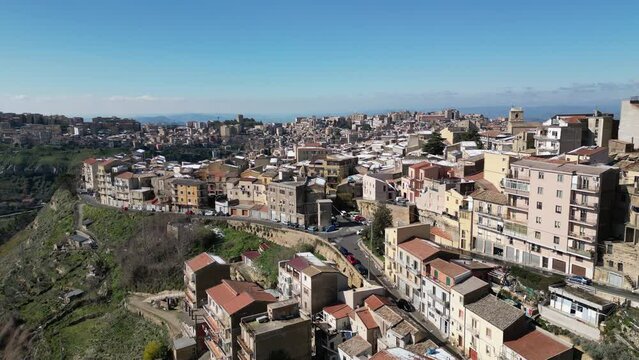 Flying past homes in beautiful hilltop village of Enna, architecture and tourism in Sicily Italy
