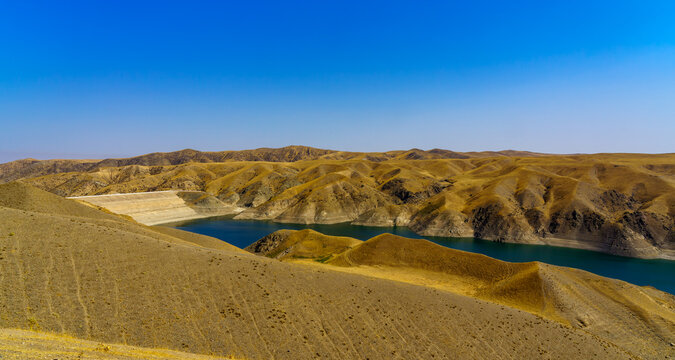A deserted part of the Zaamin nature reserve in Uzbukistan on a sunny summer day. View of the mountains and reservoir.