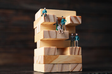 High-rise building design concept, jenga game, on dark background.