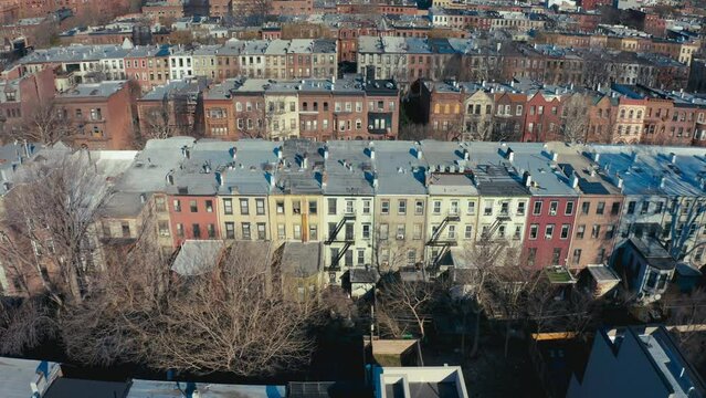 Incredible aerial drone shot of rows Brooklyn New York apartments and tenement buildings.