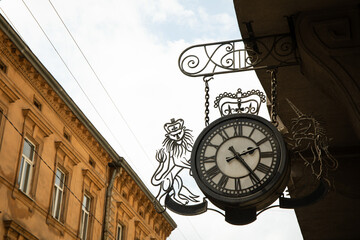 Fototapeta na wymiar Ancient clock on the wall of the house