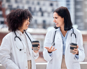 Conversation, coffee and young women doctors talking on medical diagnosis on hospital rooftop....