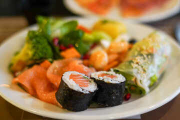 Japanese cuisine. Sushi, rolls and fresh red fish on the plate