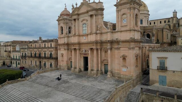 Italy architecture and religion, ascending drone shot of beautiful cathedral (Basilica Cattedrale di San Nicolo) in Noto Sicily
