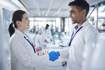 Science, handshake and man with woman in laboratory for agreement, deal or onboarding. Teamwork,...