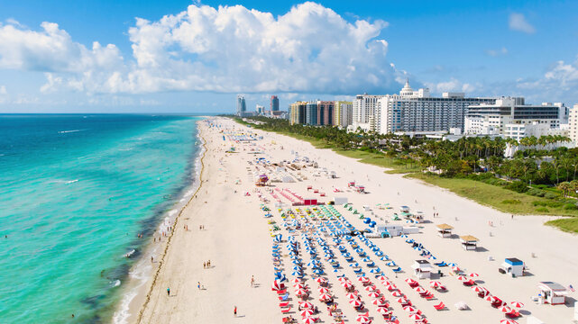 Drone aerial view at Miami South Beach Florida. Beach with colorful chairs and umbrellas, top view of the beach in Miami Florida