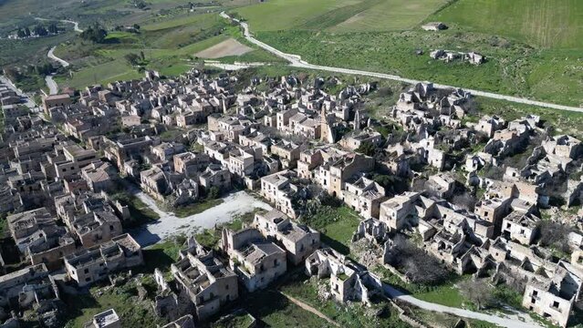Tilting aerial footage of ruins of Poggioreale, a village that was severely damaged by the 1968 Belice earthquake in Sicily Italy
