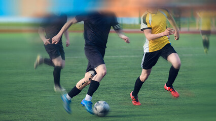 Color background with motion-blurred silhouettes of football athletes fighting for the ball.