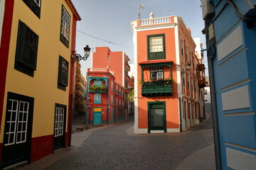 Traditional and colorful house facades located along a commercial street (calle Anselmo Perez de...