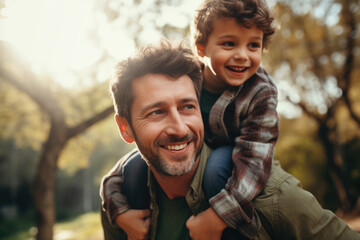 Father and son smiling outdoors. The concept is joyful family time.
