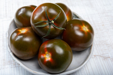 Fresh ripe sweet reddish brown and green kumato tomatoes