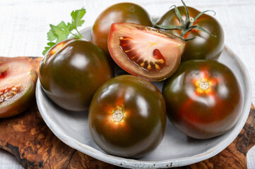 Fresh ripe sweet reddish brown and green kumato tomatoes