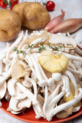 Ingredients for dinner dish with potato and mushrooms with onion. White shimeji edible mushrooms native to East Asia, buna-shimeji is widely cultivated