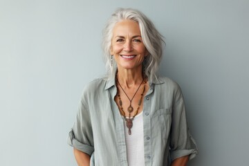portrait of a beautiful  50s mid age beautiful senior model woman with grey hair smiling