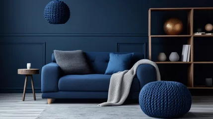 Foto op Canvas Two knitted poufs near dark blue corner sofa. Scandinavian home interior design of modern living room © Marry