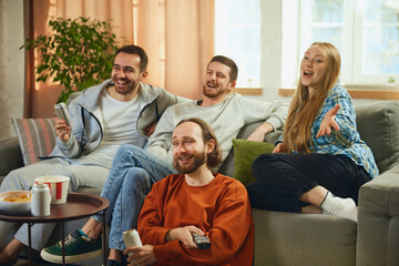 Group portrait of young people, friends watch film carefully and rejoice at happy and good ending...