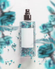 Natural perfume spray bottle with blue flowers at white background, top view. Label mockup