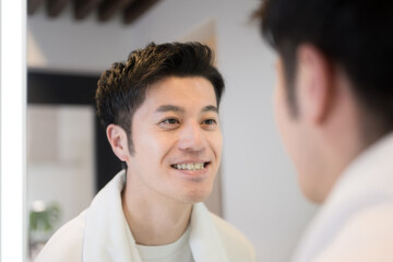 Fototapeta premium Men looking in the mirror and worrying about their teeth.