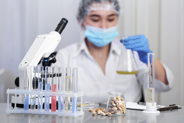 Pistachios on table and scientist proceeding quality control in laboratory