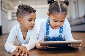Children, youth and tablet for streaming in home on web, internet or app for entertainment. Siblings, little girl and boy with technology for learning, game and fun by lying, floor and living room