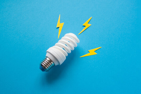 Light bulb with energy lightings on blue background. Idea concept. Energy and electricity. Innovation and thinking out the box symbols. Creativity and inspiration