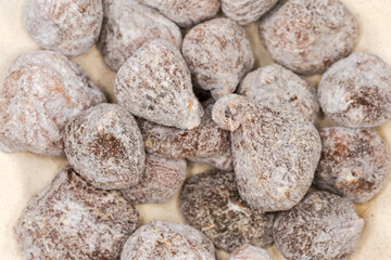 Dried figs on dish, top view close-up, selective focus