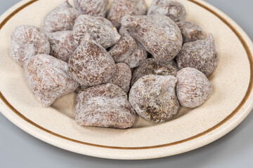 Dried figs on saucer on a gray background close-up