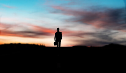 silhouette of a  businessman in the sunset