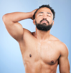Shower, cleaning and relax man with shampoo and calm from water, skincare and morning routine. Bathroom, cosmetics and male model in studio with blue background and dermatology for wellness and wash