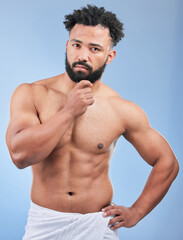 Obraz premium Bath towel, portrait and man shower, grooming and morning self care maintenance, body cleaning or fresh aesthetic wash. Bathroom skincare, spa salon sauna and studio person hygiene on blue background