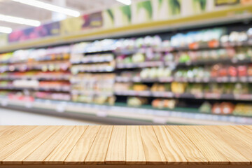 Empty wood table top with supermarket blurred background for product display