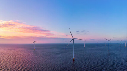 Windmill turbines Park at sunset, windmill turbine in the ocean. Netherlands Europe, green energy transition in Europe